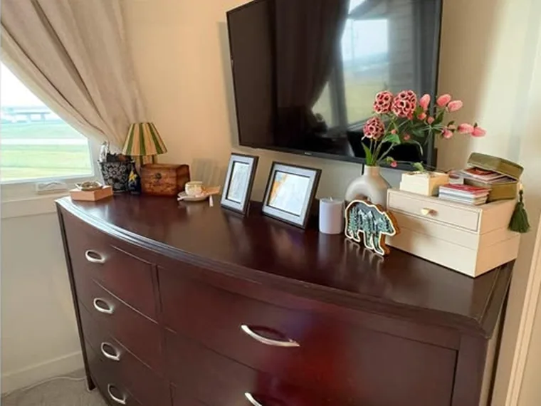 Dresser after cleaning, polished with frames and flowers